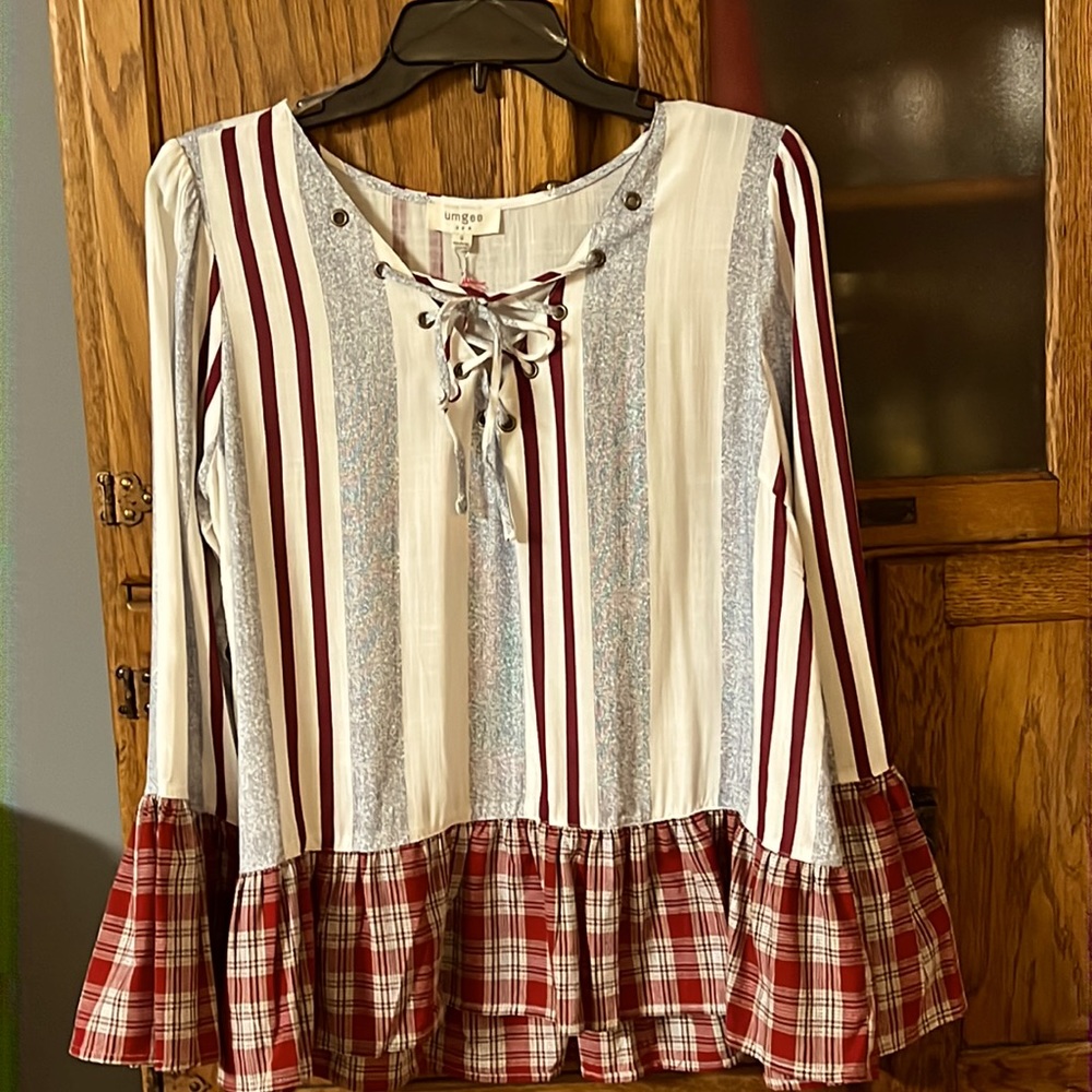 Top:stripes/plaid trim on the ruffle bottom and plaid trim on the sleeves. NWT